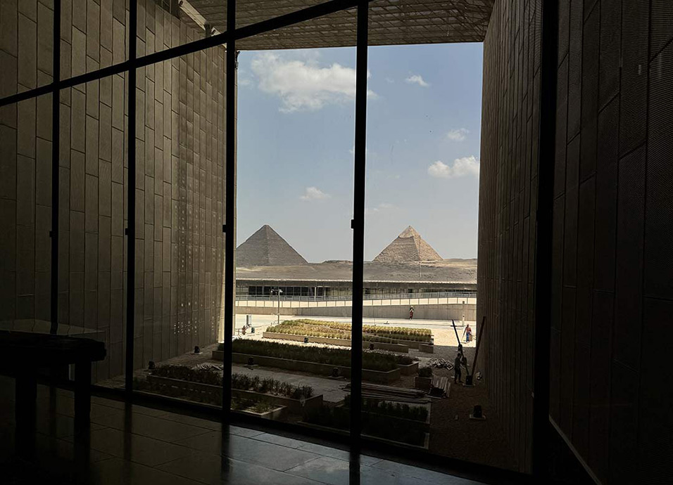 The pyramids of Giza seen through the windows of the Grand Egyptian Museum building
